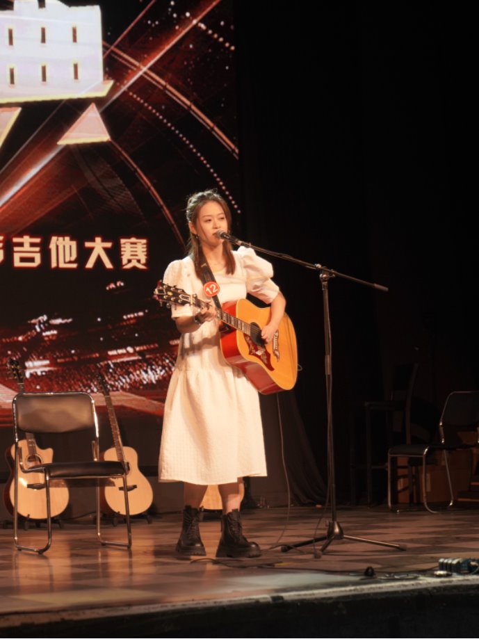 Female contestant singing and playing guitar